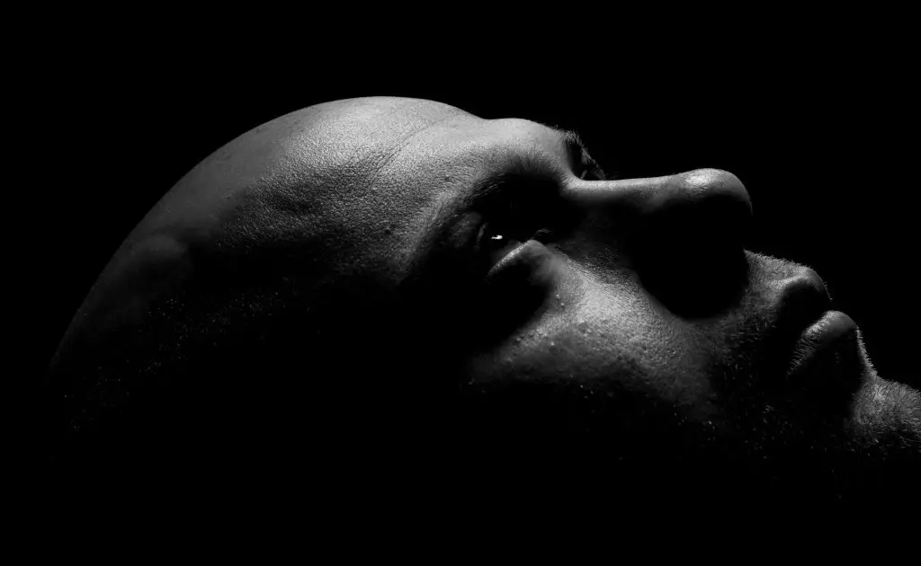 A Monochrome photography of a person who is in deep thought of hair transplant surgery.